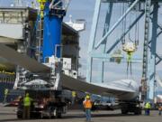 Workers unload wind blades bound for Canada from the MV Star Kilimanjaro at the Port of Vancouver on Monday morning. The ship departed China on April 13 and held 27 blades for nine wind turbines.