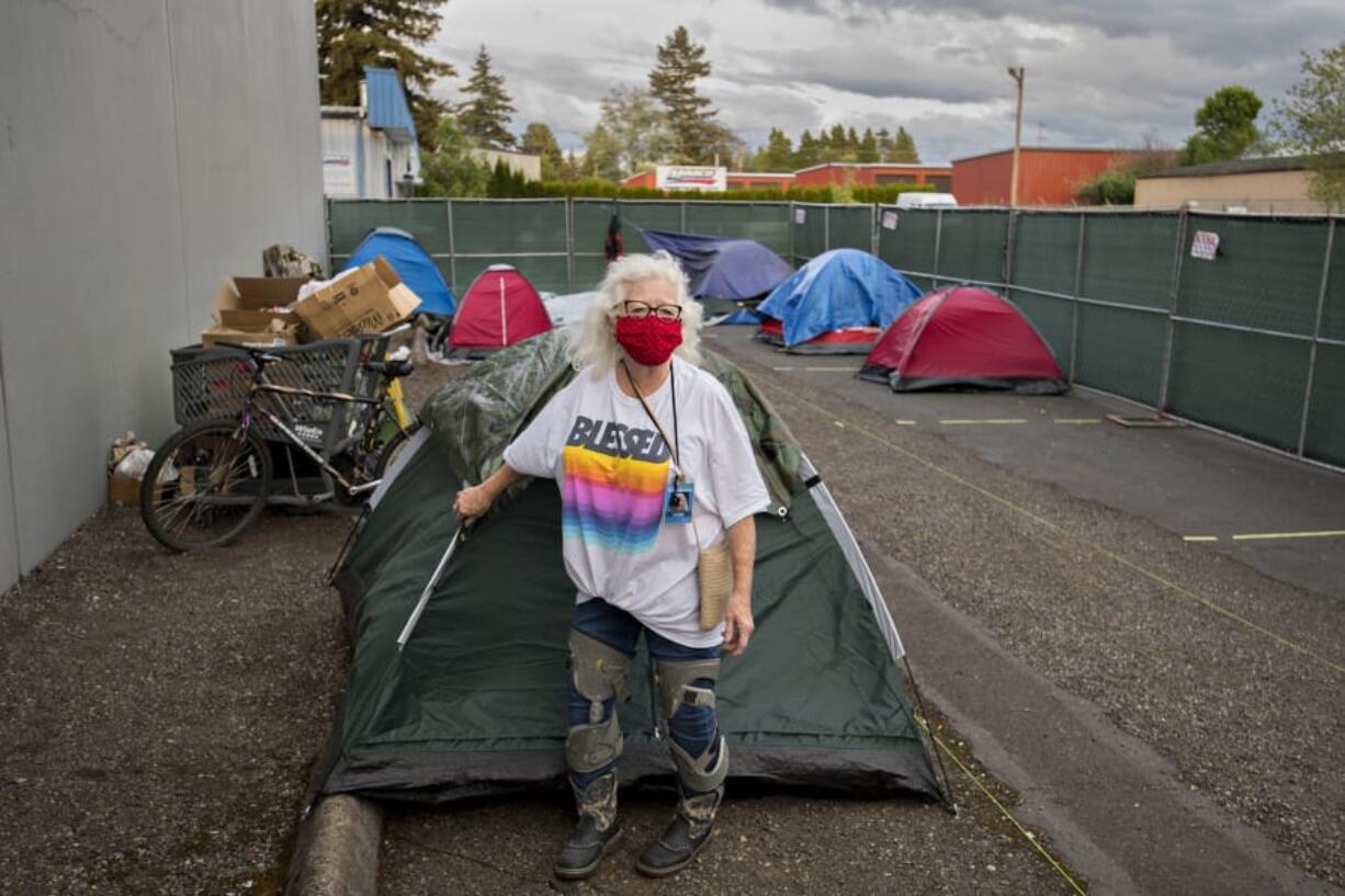 Linda Karschney volunteers Tuesday evening at the temporary homeless encampment outside Living Hope Church. Karschney is among several helpers from the congregation providing shelter, showers, snacks and restrooms to people without homes during the COVID-19 pandemic.