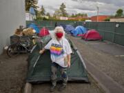 Linda Karschney volunteers Tuesday evening at the temporary homeless encampment outside Living Hope Church. Karschney is among several helpers from the congregation providing shelter, showers, snacks and restrooms to people without homes during the COVID-19 pandemic.