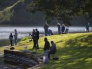 Fishing enthusiasts of all ages gather along the shoreline while keeping their distance at Klineline Pond in Salmon Creek on Tuesday morning. Tuesday was the first day fishing was allowed after Gov. Jay Inslee previously closed down the activity during the COVID-19 pandemic.