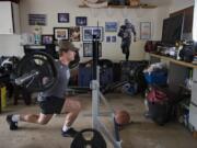 Mountain View's Riley McCarthy powers through his at-home training regimen in his family's garage Monday afternoon, May 11, 2020.