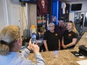 Marykay Lamoureaux, left, executive director of Ridgefield Main Street, records a video of Tammy Curlett, owner of Three-Sixty Burgers &amp; Brews, and her children, Robert and Breeanna Skeffington, on Friday afternooon as they encourage residents to shop locally.