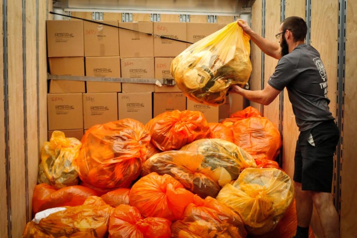 Dylan Denault, a driver with Two Men and a Truck, loads 5,000 bras donated from Ridwell in Seattle last week. Ridwell collected the bras for the National Women&#039;s Coalition Against Violence &amp; Exploitation in Vancouver.