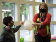 Boomerang Therapy Works co-owner and physical therapist JJ Flentke, left, works with patient Nancy Warren in Vancouver. The office opened back up on May 1 after six weeks of telehealth visits. They are taking extra safety precautions, with more frequent sanitizing, physical distancing and requiring people to wear a mask.