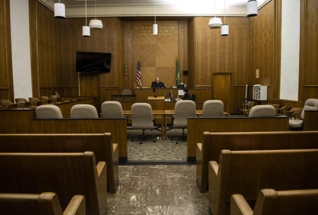 Clark County Superior Court Judge Scott Collier runs through the Adult Drug Court docket over the phone in an empty courtroom on Thursday. Many of the drug court programs are currently being conducted over the phone or over video due to the coronavirus pandemic.