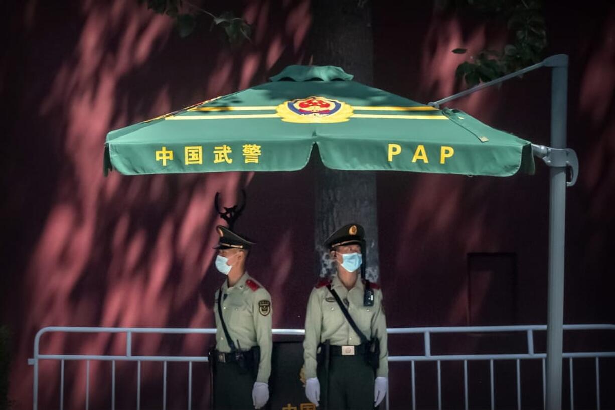 In this Wednesday, May 20, 2020, photo, Chinese paramilitary police stand guard near Tiananmen Square and the Great Hall of the People in Beijing. This year&#039;s version of China&#039;s biggest political meeting of the year will be unlike any other. Delayed from March because of the then-spiraling coronavirus outbreak, the decision to go ahead with the gathering signals a partial return to normalcy in the country where the pandemic first broke out. &quot;Partial&quot; being the operative word: The congress will be far from normal.