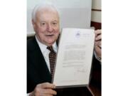 FILE - In this Nov. 7, 2005, file photo, former Australian Prime Minister Gough Whitlam holds up the original copy of his dismissal letter he received from then Governor-General Sir John Kerr on Nov. 11, 1975, at a book launch in Sydney, Australia. The High Court&#039;s majority decision in historian Jenny Hocking&#039;s appeal on Friday, May 29, 2020 overturned lower court rulings that more than 200 letters between the monarch of Britain and Australia and Governor-General Sir John Kerr before he dismissed Prime Minister Gough Whitlam&#039;s government were personal and might never be made public.