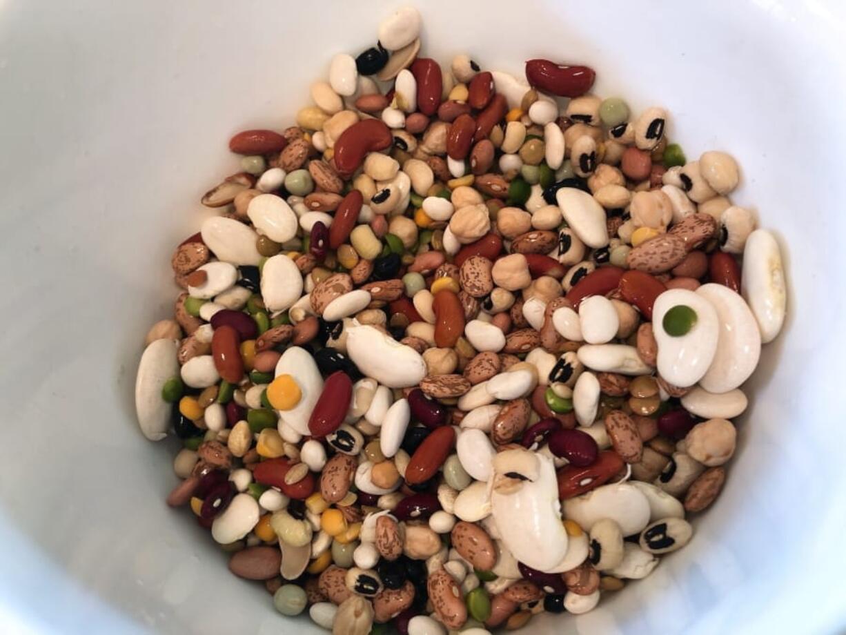 This April 1, 2020 photo shows dried mixed beans being prepared for a stone soup recipe in Amagansett, N.Y. Almost anything tastes good with beans. You can add what you have in the house like mushrooms, potatoes and corn to the soup.