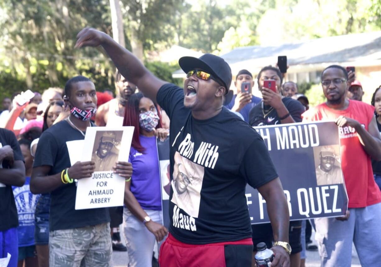 CORRECTS SPELLING OF FIRST NAME TO AHMAUD INSTEAD OF AHMOUD - In this Tuesday, May 5, 2020, photo, Keith Smith speaks to a crowd as they march through a neighborhood in Brunswick, Ga. They were demanding answers regarding the death of Ahmaud Arbery. An outcry over the Feb. 23 shooting of Arbery has intensified after cellphone video that lawyers for Arbery&#039;s family say shows him being shot to death by two white men.