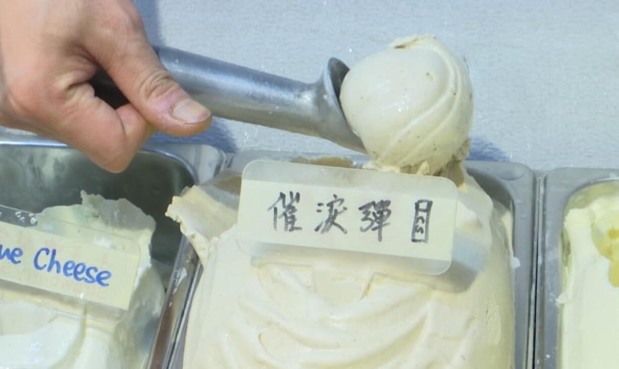 This May 4, 2020, image made from video shows a scoop of tear gas flavor ice cream, in Hong Kong. A Hong Kong ice cream shop has created this flavor using pepper, in memory of all the tear gas fired by the Hong Kong police in recent months. The flavor is a sign of support for the pro-democracy movement, which is seeking to regain its momentum during the coronavirus pandemic, the shop&#039;s owner said.