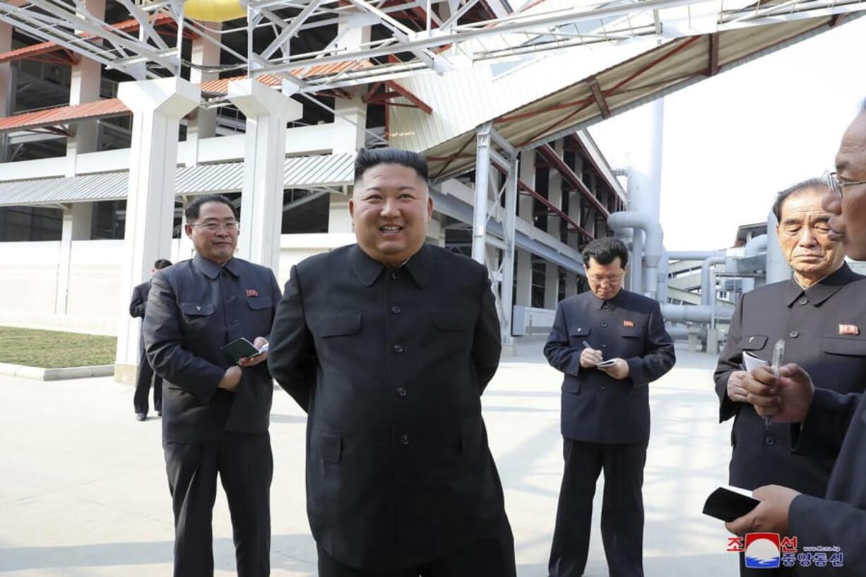 In this photo released by the North Korean government,
Kim Jong Un, center, visits a fertilizer factory Friday in Sunchon, North Korea. (Korean Central News Agency/ Korea News Service)