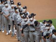 Hanwha Eagles players wearing face masks line up during the start of their regular season baseball game against SK Wyverns in Incheon, South Korea, Tuesday, May 5, 2020. Cheerleaders danced beneath rows of empty seats and umpires wore protective masks as a new baseball season began in South Korea. After a weeks-long delay because of the coronavirus pandemic, a hushed atmosphere allowed for sounds like the ball hitting the catcher&#039;s mitt and bats smacking the ball for a single or double to echo around the stadium.