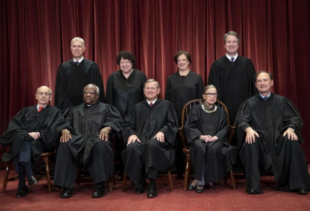 FILE - In this Nov. 30, 2018, file photo, the justices of the U.S. Supreme Court gather for a formal group portrait to include the new Associate Justice, top row, far right, at the Supreme Court building in Washington. Seated from left: Associate Justice Stephen Breyer, Associate Justice Clarence Thomas, Chief Justice of the United States John G. Roberts, Associate Justice Ruth Bader Ginsburg and Associate Justice Samuel Alito Jr. Standing behind from left: Associate Justice Neil Gorsuch, Associate Justice Sonia Sotomayor, Associate Justice Elena Kagan and Associate Justice Brett M. Kavanaugh. On Monday, May 4, 2020, the Supreme Court for the first time audio of court&#039;s arguments will be heard live by the world and the first arguments by telephone. (AP Photo/J.