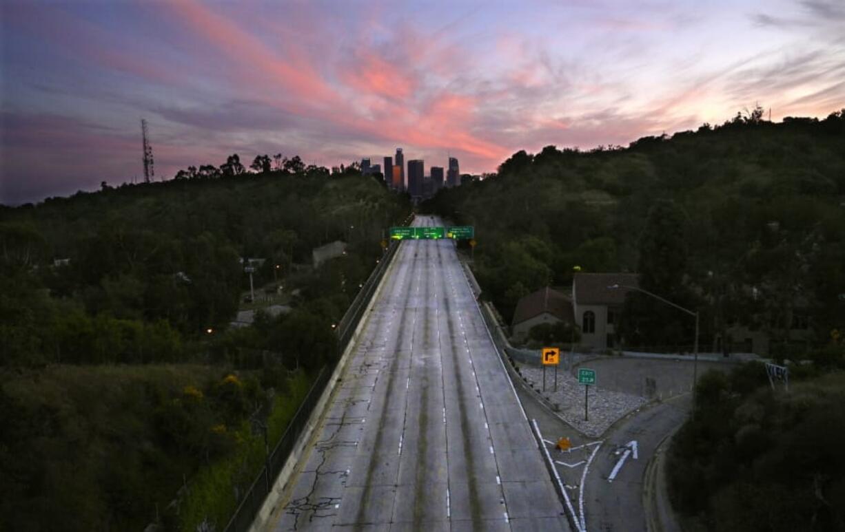 FILE - In this April 26, 2020, file photo, empty lanes of the 110 Arroyo Seco Parkway that leads to downtown Los Angeles is seen during the coronavirus outbreak in Los Angeles, Calif. The world cut its daily carbon dioxide emissions by 17 percent at the peak of the pandemic shutdown last month, a new study found.  But with life and heat-trapping gas levels inching back toward normal, the brief pollution break will likely be &quot;a drop in the ocean&quot; when it comes to climate change, scientists said.(AP Photo/Mark J.