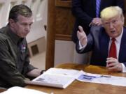 FILE - In this Sept. 9, 2019, file photo, President Donald Trump participates in a briefing about Hurricane Dorian with North Carolina Gov. Roy Cooper, left, aboard Air Force One at Marine Corps Air Station Cherry Point in Havelock, N.C.  President Donald Trump demanded Monday, May 25, 2020, that North Carolina&#039;s Democratic governor sign off &quot;immediately&quot; on allowing the Republican National Convention to move forward in August with full attendance despite the ongoing COVID-19 pandemic.