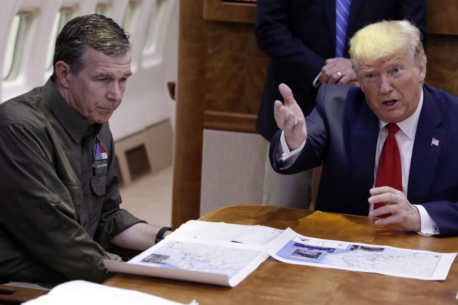 FILE - In this Sept. 9, 2019, file photo, President Donald Trump participates in a briefing about Hurricane Dorian with North Carolina Gov. Roy Cooper, left, aboard Air Force One at Marine Corps Air Station Cherry Point in Havelock, N.C.  President Donald Trump demanded Monday, May 25, 2020, that North Carolina&#039;s Democratic governor sign off &quot;immediately&quot; on allowing the Republican National Convention to move forward in August with full attendance despite the ongoing COVID-19 pandemic.