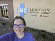 In this Wednesday, April 29, 2020 photo selfie provided by Dr. Beth Oller, Oller, a family physician, smiles while standing outside her medical clinic, just south of Main Street in Stockton, Kan. Oller began preaching social distancing well before her home of Rooks County confirmed its first coronavirus case and now she&#039;s nervous about the state reopening its economy too soon. (Dr.