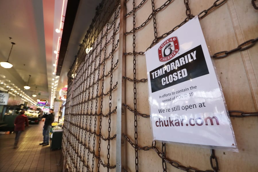 A sign explains the closure of a shop in the Pike Place Market in Seattle.