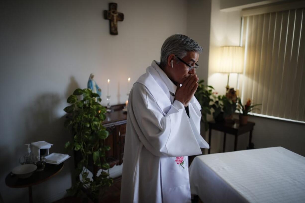 Fabian Arias, a Lutheran pastor with Saint Peter&#039;s Church in Manhattan, prepares to give Sunday services at his home via an internet livestream broadcast.