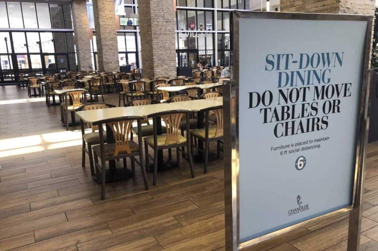 After being closed for several weeks due to the coronavirus outbreak, Chandler Fashion Center Mall welcomes back patrons with many social distancing guideline signs Sunday, May 17, 2020, in Chandler, Ariz.  Much of the country remains unlikely to venture out to bars, restaurants, theaters or the gym anytime soon, despite state and local officials increasingly allowing businesses to reopen. That&#039;s according to a new survey by The Associated Press-NORC Center for Public Affairs Research.  (AP Photo/Ross D.