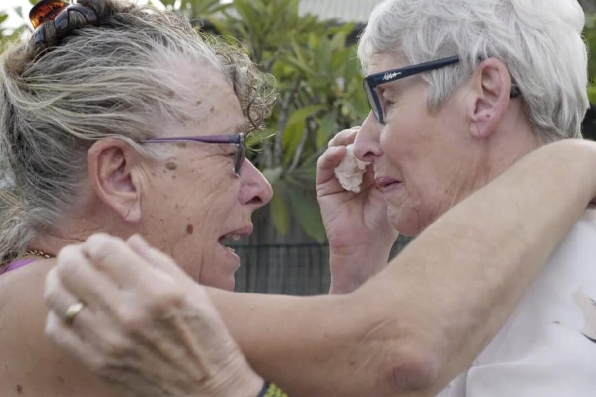 Christine Archer, right, and her sister Gail Baker cry as they are reunited in Bowraville, Australia Wednesday, May 20, 2020. Australia had rejected Archer&#039;s request for permission to fly from New Zealand four times before her story attracted media attention. Her only sister Baker was diagnosed with incurable ovarian cancer in late March after both countries stopped international travel. Baker has perhaps weeks to live. Archer was eventually allowed to fly to Sydney and spent only a week in hotel quarantine before testing negative for the coronavirus.