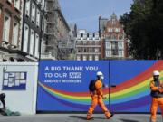 A construction worker passes a sign thanking the NHS in London, as the country in is lockdown to prevent the spread of coronavirus, Thursday, May 7, 2020. The coronavirus has had a dramatic impact on the construction industry. The Bank of England has warned that the British economy could be nearly a third smaller by the end of the first half of this year as a result of the coronavirus pandemic, but also notes the economy could revive quickly.