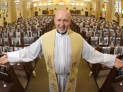 FILE - In this May 22, 2020, file photo, the Rev. Nicolas Sanchez Toledano poses among pews adorned with portraits of his parishioners at St. Patrick&#039;s Catholic Church during the coronavirus outbreak in the North Hollywood section of Los Angeles. California says churches can resume in-person services but the congregations will be limited to less than 100 and worshippers should wear masks, avoid sharing prayer books and skip the collection plate. The state Department of Public Health released a framework Monday, May 25, for county health officials to permit houses of worship to reopen.  (AP Photo/Mark J.