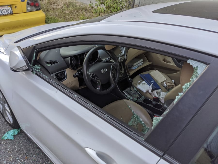 This Thursday, May 21, 2020, photo shows a parked car with a broken driver&#039;s side window after a smash-and-grab break-in in Los Angeles. The coronavirus hasn&#039;t been kind to car owners. With more people than ever staying home to lessen the spread of COVID-19, their sedans, pickup trucks and SUVs are parked unattended on the streets, making them easy targets for opportunistic thieves.