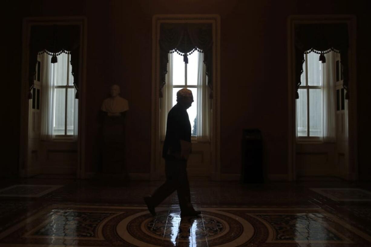 FILE - In this April 9, 2020, file photo Senate Majority Leader Mitch McConnell of Ky., walks to the Senate chamber on Capitol Hill in Washington. The Senate is set to resume Monday, May 4.