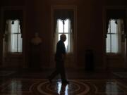 FILE - In this April 9, 2020, file photo Senate Majority Leader Mitch McConnell of Ky., walks to the Senate chamber on Capitol Hill in Washington. The Senate is set to resume Monday, May 4.