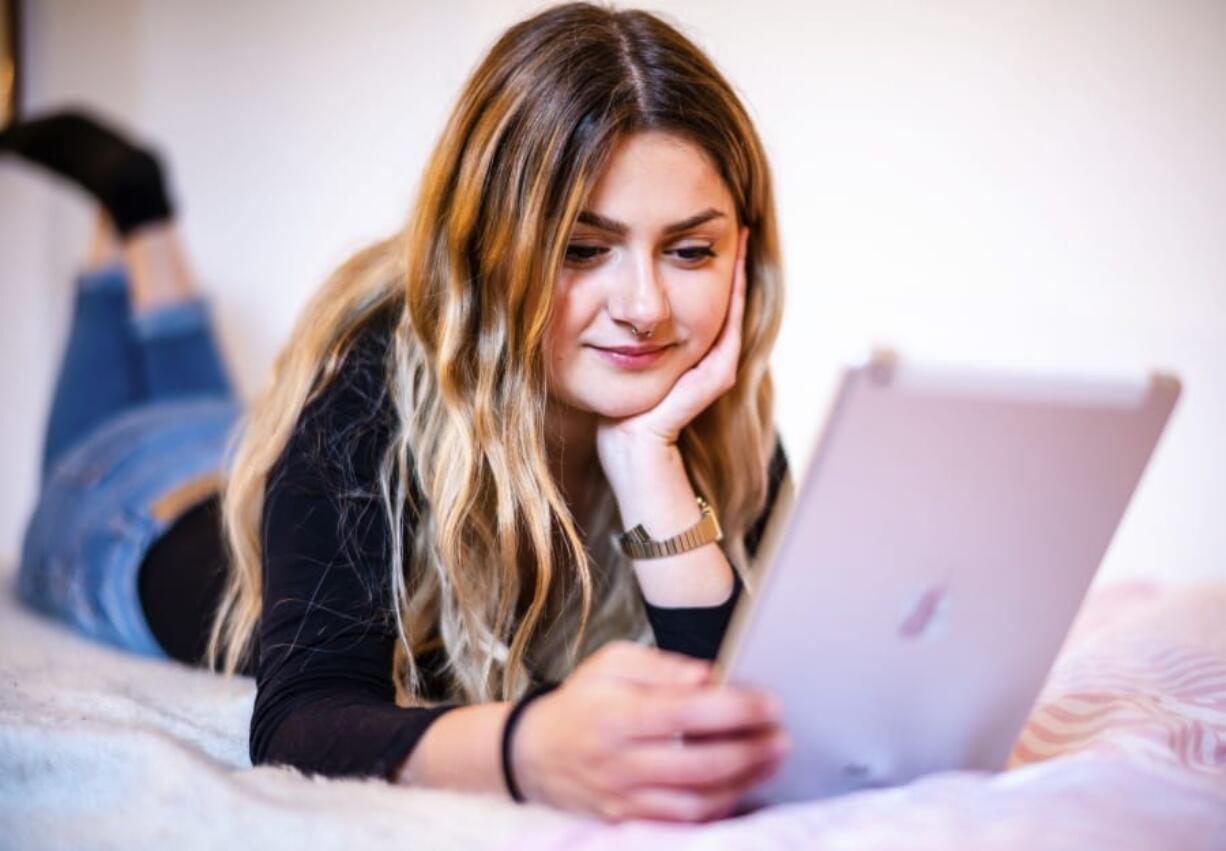 Bianca Amodeo, 17, uses her tablet in her room at home in Ascoli Piceno, central Italy, Thursday, April 30, 2020 to chat with her boyfriend Francesco who lives in Ancarano, 15 minutes driving from home. Bianca and Francesco have not met for almost two months after Italy went in a general lockdown in a bid to fight the new coronavirus pandemic. While Italian Premier Conte announced the first relaxation of the circulation restrictions starting from May 4, Bianca and Francesco won&#039;t be able to meet yet because they live in different regions.