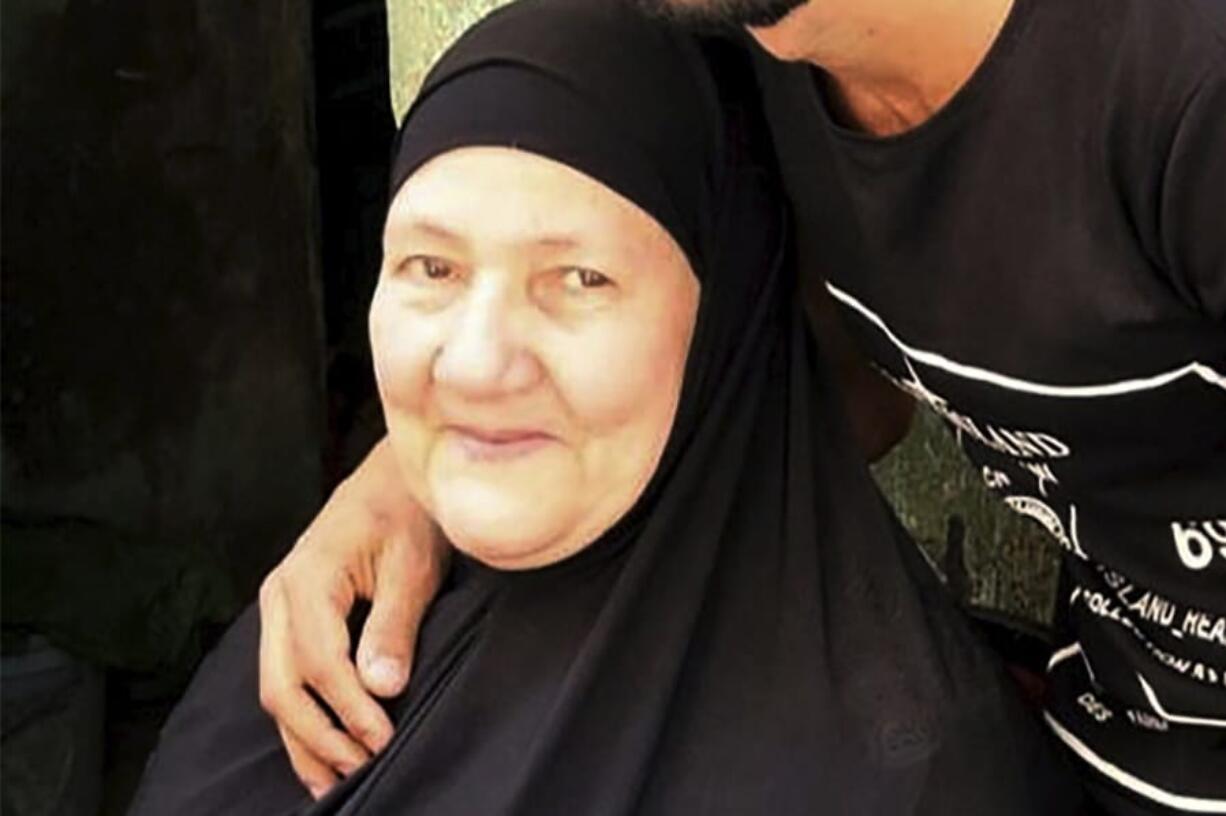 This undated handout image provided by the family of El-Sayed, shows Ghaliya Abdel-Wahab, who died from COVID-19 on April 6, 2020, poses for a photograph with her grandson, in the Shubra el-Kheima neighborhood, Qalyoubiya governorate, Egypt. The novel coronavirus struck her family with horrific speed, infecting 45 of her relatives.