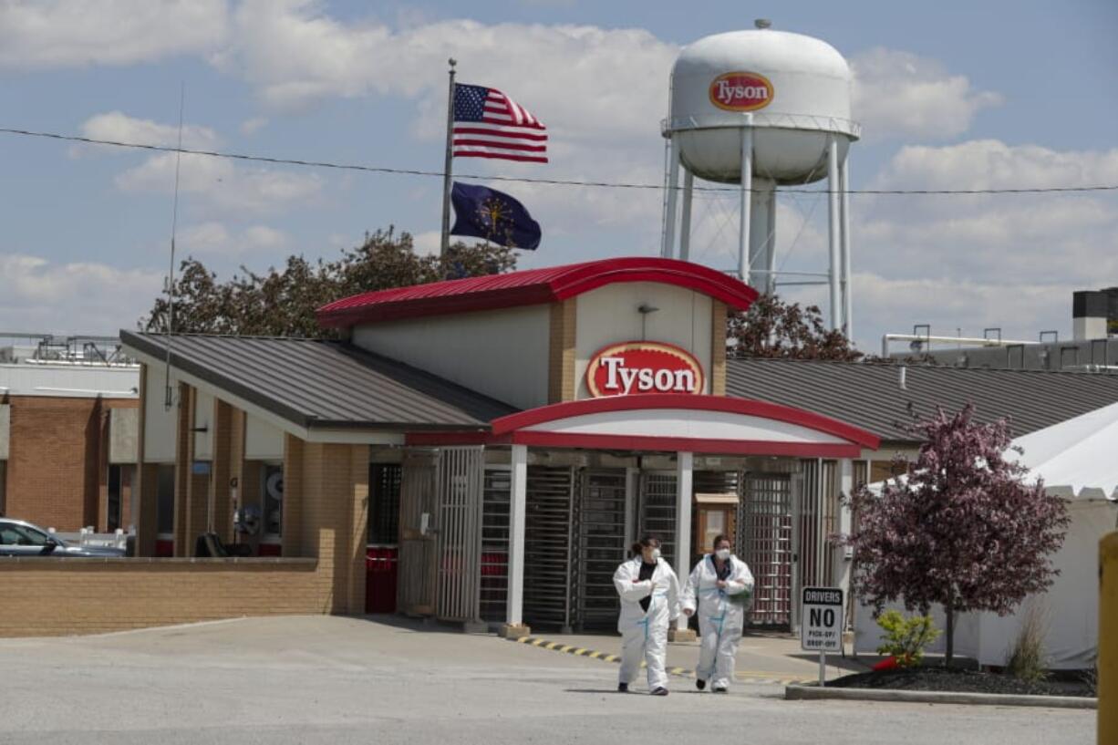 FILE - In this May 7, 2020, file photo, workers leave the Tyson Foods pork processing plant in Logansport, Ind. Federal recommendations meant to keep meatpacking workers safe as they return to plants that were shuttered by the coronavirus have little enforcement muscle behind them, fueling anxiety that working conditions could put employees&#039; lives at risk. Major meatpackers JBS, Smithfield and Tyson have said worker safety is their highest priority.