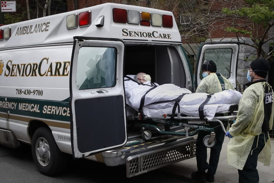 FILE - In this April 17, 2020, file photo, a patient is loaded into an ambulance by emergency medical workers outside Cobble Hill Health Center in the Brooklyn borough of New York. New York state is now reporting more than 1,700 previously undisclosed deaths at nursing homes and adult care facilities as the state faces scrutiny over how it&#039;s protected vulnerable residents during the coronavirus pandemic.