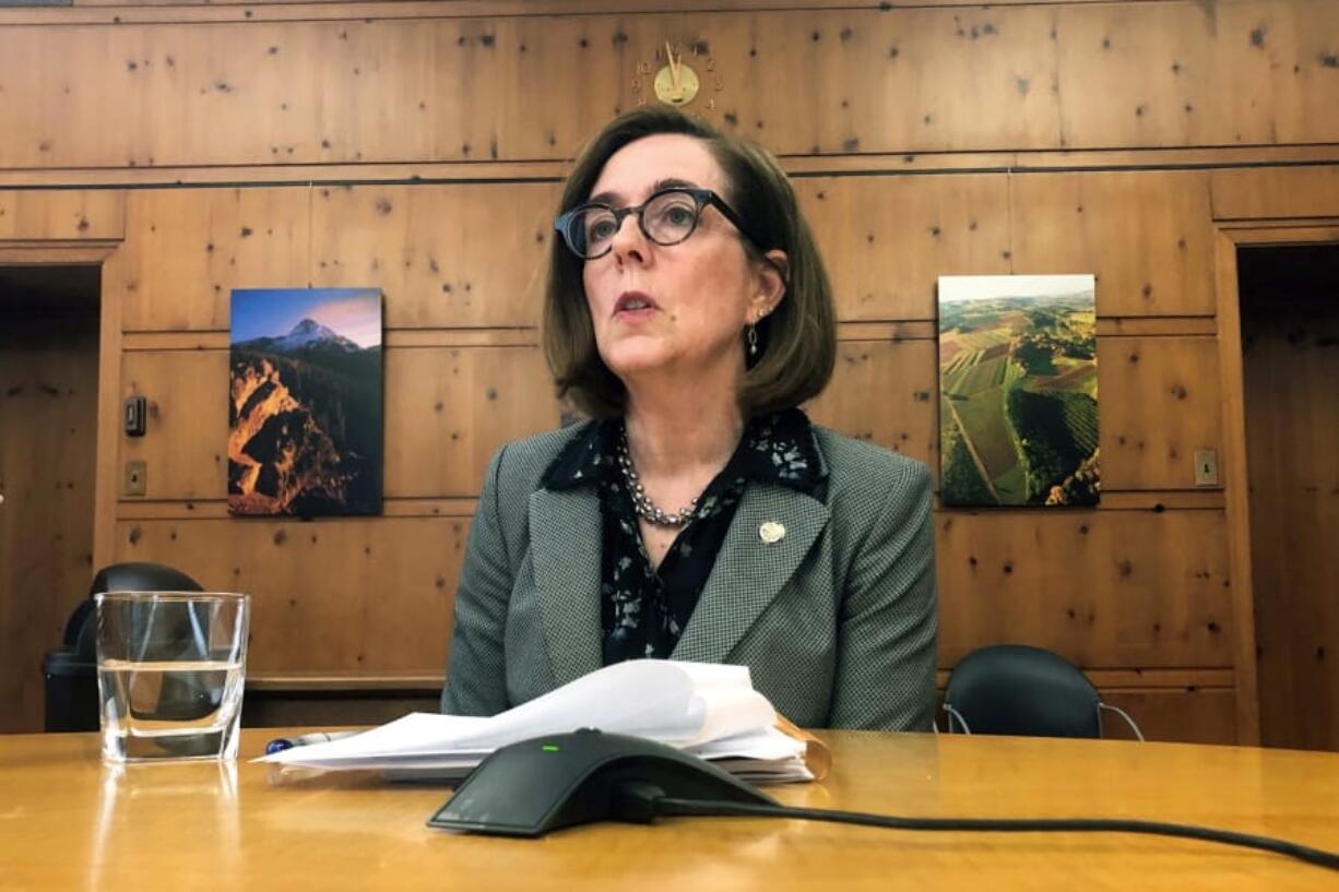 FILE - In this July 1, 2019, file photo, Oregon Gov. Kate Brown speaks with the media at the Capitol in Salem, Ore., on July 1, 2019.  A county judge has declared Oregon Gov. Kate Brown&#039;s coronavirus restrictions &quot;null and void&quot; because she didn&#039;t have her emergency orders approved by the Legislature following 28 days.