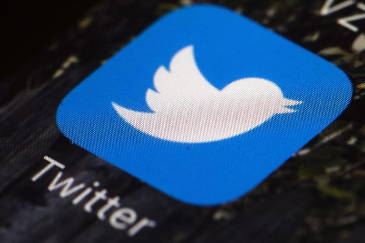 FILE - This April 26, 2017, file photo shows the Twitter app icon on a mobile phone in Philadelphia. Facebook, Google, Twitter and other platforms are taking unprecedented steps to protect public health as potentially dangerous coronavirus misinformation spreads around the world. The companies are removing potentially dangerous misinformation promoted by politicians and others, while directing users to credible information from sources like the World Health Organization.