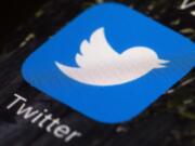 FILE - This April 26, 2017, file photo shows the Twitter app icon on a mobile phone in Philadelphia. Facebook, Google, Twitter and other platforms are taking unprecedented steps to protect public health as potentially dangerous coronavirus misinformation spreads around the world. The companies are removing potentially dangerous misinformation promoted by politicians and others, while directing users to credible information from sources like the World Health Organization.