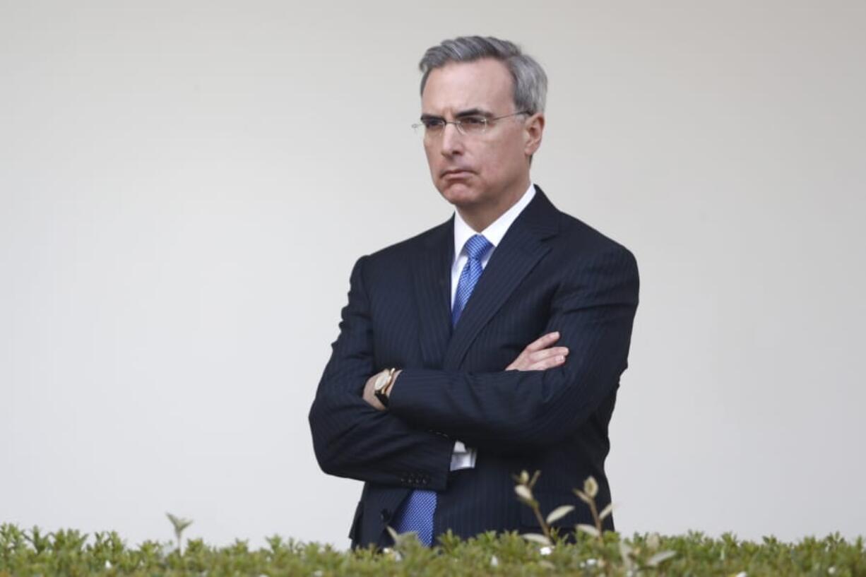 White House counsel Pat Cipollone listens as President Donald Trump speaks during a coronavirus task force briefing in the Rose Garden of the White House, Sunday, March 29, 2020, in Washington.