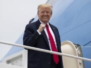 President Donald Trump pumps his fist while boarding Air Force One as he departs Thursday, May 21, 2020, at Andrews Air Force Base, Md. Trump will visit a Ypsilanti, Mich., Ford plant that has been converted to making personal protection and medical equipment.