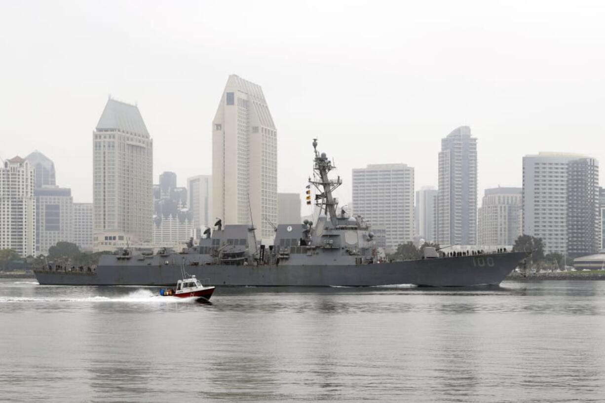 In this April 28, 2020, photo, the USS Kidd passes downtown San Diego as it returns to Naval Base San Diego, seen from Coronado, Calif.