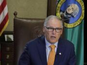 Washington Gov. Jay Inslee sits at his desk and rehearses a speech Tuesday, April 21, 2020, at the Capitol in Olympia, Wash., minutes before going live to address the public on the state&#039;s next steps in addressing the coronavirus outbreak. Inslee said the state will not be able to lift many of the stay-at-home restrictions implemented to fight the coronavirus by May 4, the date through which the existing directive is currently in place. (AP Photo/Ted S.