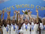 United States&#039; Megan Rapinoe lifts up the trophy after winning the Women&#039;s World Cup final last summer.