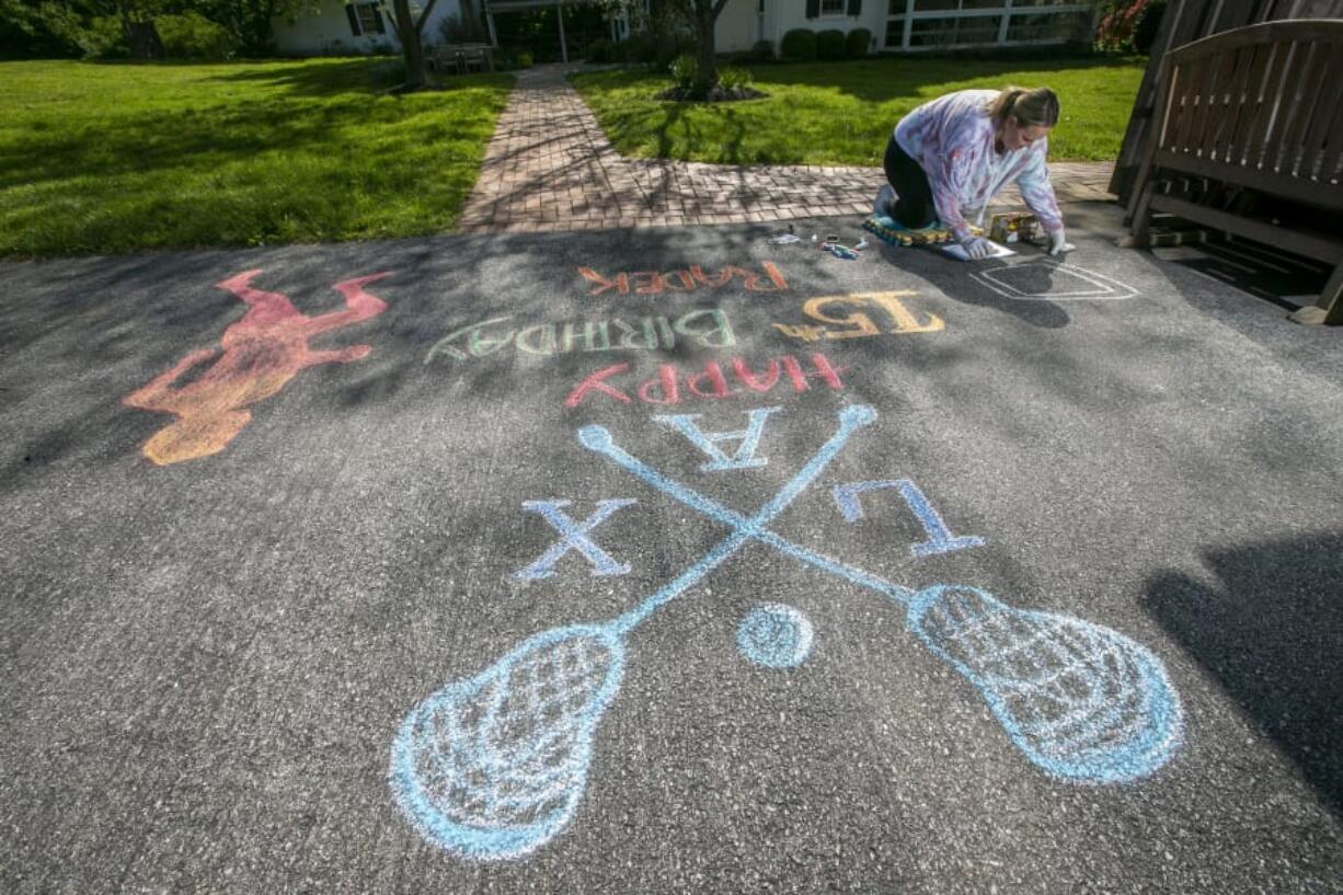 Stefanie Heron-Birl, former face painter, now chalk drawer because of social distancing, creates a drawing on the driveway of Kate Semon&#039;s house on Allerton Road in West Chester, Pa. This drawing is for Radek Semon to help celebrate his 15th birthday. (Alejandro A.