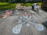 Stefanie Heron-Birl, former face painter, now chalk drawer because of social distancing, creates a drawing on the driveway of Kate Semon&#039;s house on Allerton Road in West Chester, Pa. This drawing is for Radek Semon to help celebrate his 15th birthday. (Alejandro A.