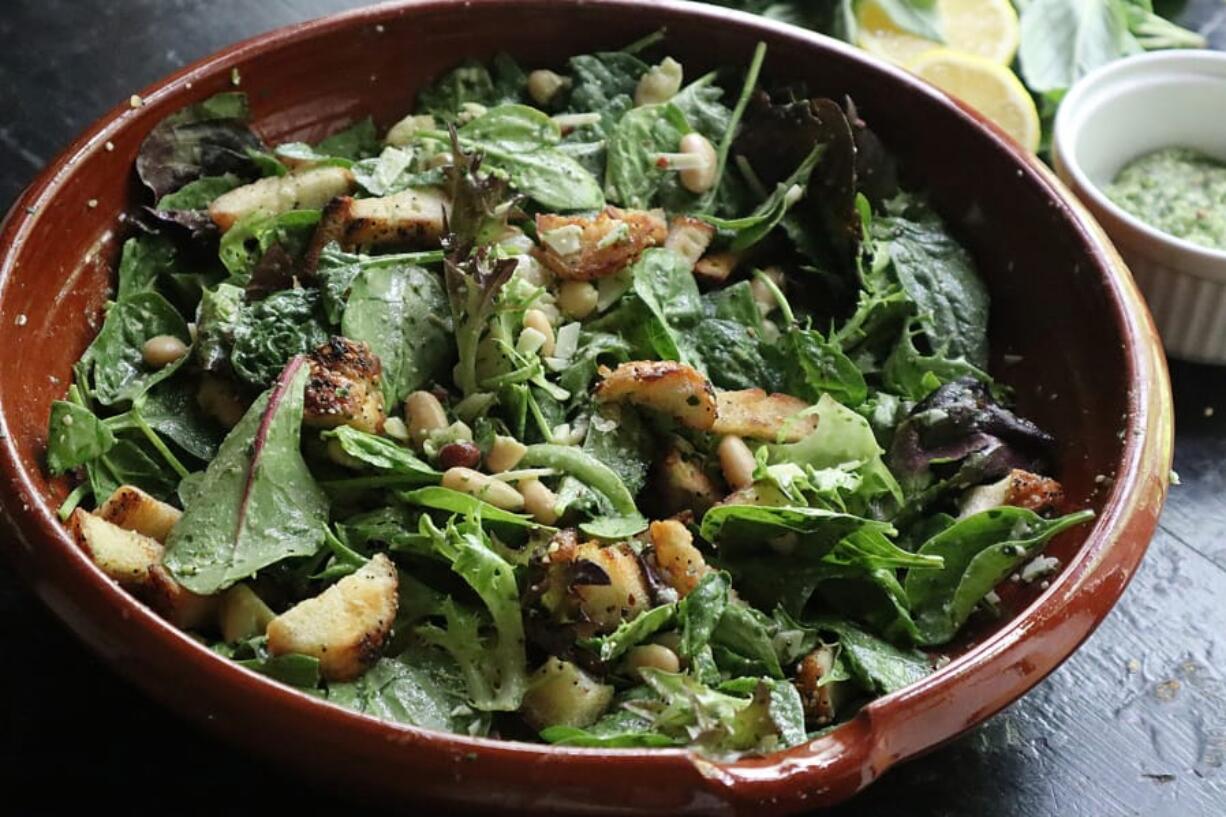 This easy, healthful salad features cannellini beans and greens tossed in a zesty lemon-basil pesto. Everything bagel croutons add crunch.