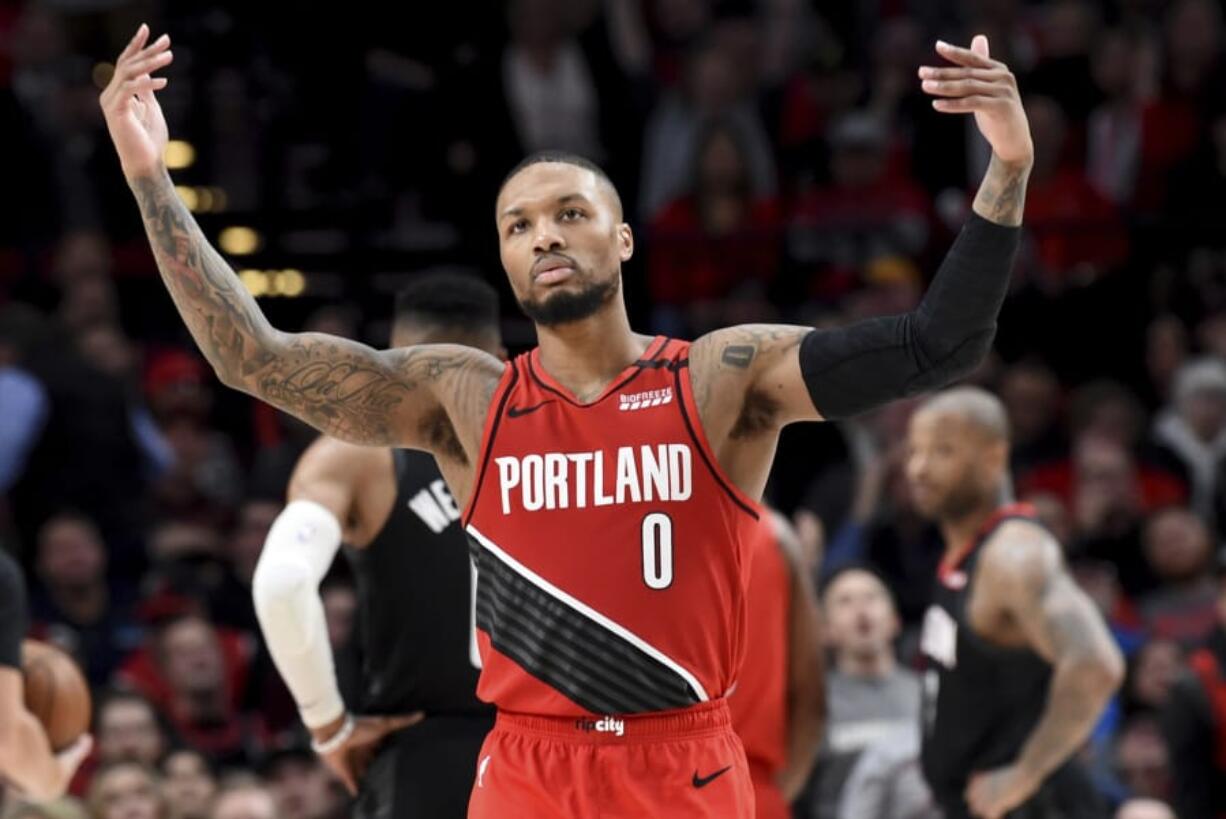 Portland Trail Blazers guard Damian Lillard urges on the crowd after scoring during the second half of the team&#039;s NBA basketball game against the Houston Rockets in Portland, Ore., Wednesday, Jan. 29, 2020. The Blazers won 125-112.