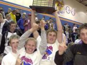 Ridgefield baseball players (from left) Jamie Kaneen, Stu Draper, Jon Parnell, and Joel Fern, celebrate their 2002 state champion during a school assembly.