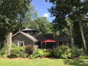 A cottage home highlighted with attractive landscaping.