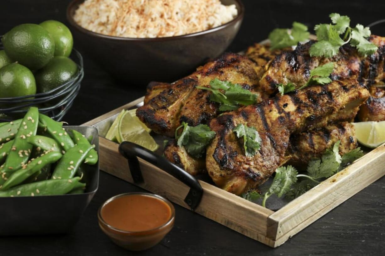 Pork country ribs marinate in a mixture of onion, garlic, ginger and lemongrass purees, fish sauce, chile, salt, pepper, coriander, cumin and turmeric before being grilled and then served with fresh lime and bottled peanut sauce.