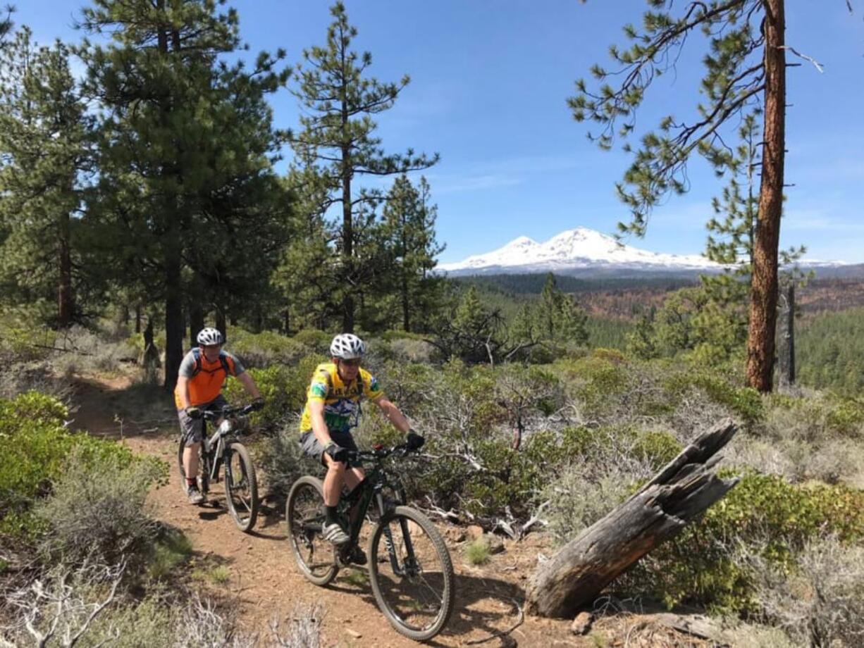 Mountain bikers ride along the Peterson Ridge West trail.